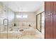Bright bathroom with a large soaking tub, tiled surround, and separate glass shower at 5112 Lanai Way, Tampa, FL 33624