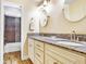 Bathroom featuring a double sink vanity with granite countertops and a tiled shower at 5112 Lanai Way, Tampa, FL 33624