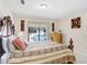 Bright bedroom features light walls, window view of pool, and artwork accenting the space at 5112 Lanai Way, Tampa, FL 33624