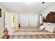 Comfortable bedroom featuring a striking headboard, plush bedding, and bright natural light at 5112 Lanai Way, Tampa, FL 33624