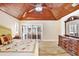 This bedroom features wood-look flooring, white walls, and a vaulted wood ceiling with a stylish ceiling fan at 5112 Lanai Way, Tampa, FL 33624