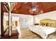 Spacious bedroom boasts wood-look flooring, vaulted wood ceiling, and a large window with bright natural light at 5112 Lanai Way, Tampa, FL 33624