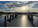 Community boardwalk with metal safety railing over water; views feature the horizon, other park features, and benches for relaxation at 5112 Lanai Way, Tampa, FL 33624