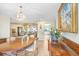 Traditional dining room featuring wood floors, a chandelier, and adjacent living spaces at 5112 Lanai Way, Tampa, FL 33624