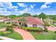 Beautiful one-story home with manicured lawn, red brick driveway, and lush landscaping at 5112 Lanai Way, Tampa, FL 33624
