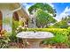 Charming front yard with a decorative water fountain, palm trees and lush landscaping at 5112 Lanai Way, Tampa, FL 33624