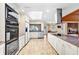 Bright kitchen with stainless steel appliances, granite countertops, and a built-in oven at 5112 Lanai Way, Tampa, FL 33624