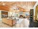 Spacious living room with a wood ceiling, fireplace, and ample seating at 5112 Lanai Way, Tampa, FL 33624