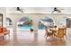 Covered patio with brick flooring offers a view of the pool with a rock waterfall feature at 5112 Lanai Way, Tampa, FL 33624