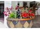 Close up of patio decor featuring vibrant floral arrangement in decorative container at 5112 Lanai Way, Tampa, FL 33624