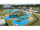 State-of-the-art community playground featuring climbing structures and swings, surrounded by lush green space and blue flooring at 5112 Lanai Way, Tampa, FL 33624