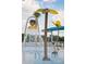 Fun splash pad featuring flower-shaped water fountains and other interactive water play features, creating a refreshing outdoor space at 5112 Lanai Way, Tampa, FL 33624