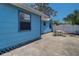 Exterior shot of a blue house featuring a concrete patio and white vinyl fence at 520 4Th Nw St, Largo, FL 33770
