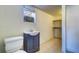 Bathroom featuring blue vanity, tile floors, toilet and an abundance of storage at 520 4Th Nw St, Largo, FL 33770