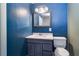 Bathroom featuring blue vanity, tile floors and a mirror at 520 4Th Nw St, Largo, FL 33770