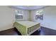 Bedroom featuring hardwood floors, two windows and a green floral bedspread at 520 4Th Nw St, Largo, FL 33770
