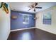 Bedroom featuring hardwood floors, a ceiling fan and two bright windows at 520 4Th Nw St, Largo, FL 33770