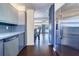 Galley kitchen featuring stainless steel refrigerator, blue cabinets, modern appliances and hardwood floors at 520 4Th Nw St, Largo, FL 33770