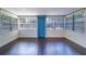 Bright sunroom with large windows and dark wood floors at 520 4Th Nw St, Largo, FL 33770
