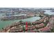 Aerial view of condo community on the water featuring pool and waterfront access at 531 Sandy Hook Rd, Treasure Island, FL 33706