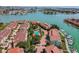 Beautiful aerial view of waterfront condos, boat docks, swimming pool, and lush landscaping at 531 Sandy Hook Rd, Treasure Island, FL 33706
