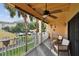 Relax on this inviting balcony with views of lush greenery, community pool, and ample seating at 531 Sandy Hook Rd, Treasure Island, FL 33706