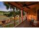 Inviting covered balcony featuring wood flooring and comfortable outdoor seating with view of well-maintained green space at 531 Sandy Hook Rd, Treasure Island, FL 33706