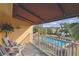 Relaxing condo balcony view with outdoor seating overlooking a pristine community pool and lush landscaping at 531 Sandy Hook Rd, Treasure Island, FL 33706