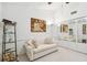 Relaxing living room area with comfy furniture, unique wall decor, and mirrored closet at 531 Sandy Hook Rd, Treasure Island, FL 33706