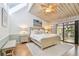 Bright bedroom featuring a vaulted ceiling, ceiling fan, and sliding glass doors to an outdoor balcony at 531 Sandy Hook Rd, Treasure Island, FL 33706