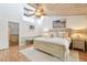 A serene bedroom featuring high ceilings with wooden beams and an ocean-themed painting at 531 Sandy Hook Rd, Treasure Island, FL 33706