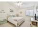Bright bedroom with a ceiling fan, serene decor, and natural light from the window at 531 Sandy Hook Rd, Treasure Island, FL 33706