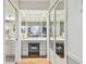 Elegant dressing area with mirrored vanity, stool, and closet, reflecting the bedroom at 531 Sandy Hook Rd, Treasure Island, FL 33706