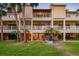 Rear exterior view of multi-story condo building with balconies and palm trees at 531 Sandy Hook Rd, Treasure Island, FL 33706