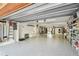 Well-organized garage with shelving units, epoxy floors, and access to the backyard at 531 Sandy Hook Rd, Treasure Island, FL 33706
