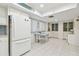 A spacious kitchen area features white cabinets, tile floors, dining table and chairs, with stylish decor at 531 Sandy Hook Rd, Treasure Island, FL 33706