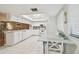 Bright kitchen features white cabinets, countertops, tiled floor, and dining area with seaside decorations at 531 Sandy Hook Rd, Treasure Island, FL 33706