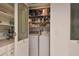 Handy Laundry room inside closet with side by side washer and dryer and overhead shelving at 531 Sandy Hook Rd, Treasure Island, FL 33706