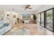 Bright living room boasts light wood flooring, entertainment center and sliding glass doors to the pool at 531 Sandy Hook Rd, Treasure Island, FL 33706
