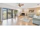 Bright living room with a stone fireplace, sliding doors to a balcony, and comfortable furnishings at 531 Sandy Hook Rd, Treasure Island, FL 33706