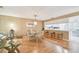 Cozy living area featuring wood laminate flooring, bar seating, and open access to the kitchen at 531 Sandy Hook Rd, Treasure Island, FL 33706