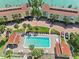 Aerial shot of community pool with lounge chairs and palm trees at 531 Sandy Hook Rd, Treasure Island, FL 33706