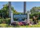 Community entrance sign amidst lush landscaping, enhancing the neighborhood's appeal at 531 Sandy Hook Rd, Treasure Island, FL 33706