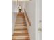 A staircase featuring light wood and a wood handrail on the right at 531 Sandy Hook Rd, Treasure Island, FL 33706