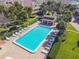 Community swimming pool with lounge chairs and a covered patio area at 531 Sandy Hook Rd, Treasure Island, FL 33706