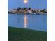 Stunning water view at night with city lights reflecting on the water under a full moon at 531 Sandy Hook Rd, Treasure Island, FL 33706