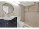 Stylish bathroom features a modern vanity, round mirror, tiled shower, and updated fixtures at 5875 Darren N Ct, Clearwater, FL 33760