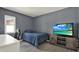 Cozy bedroom with a bed, TV and desk at 5875 Darren N Ct, Clearwater, FL 33760