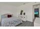 Bright bedroom featuring a bed, white bookcase, and light hardwood floors at 5875 Darren N Ct, Clearwater, FL 33760