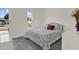 Bright bedroom featuring a bed, window with a view, and light hardwood floors at 5875 Darren N Ct, Clearwater, FL 33760